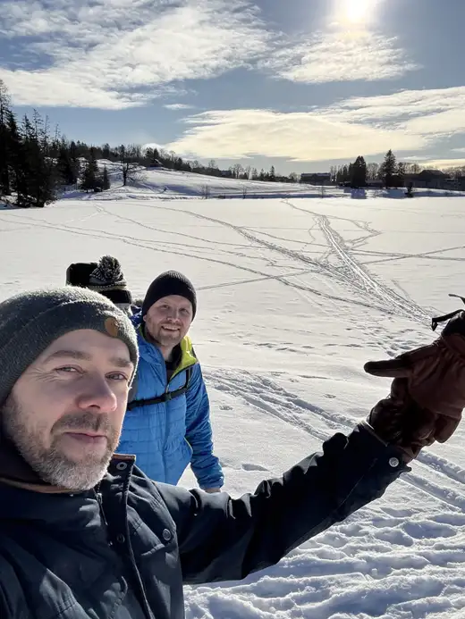 Kristoffer and Finn on a snow-covered field in winter sun.